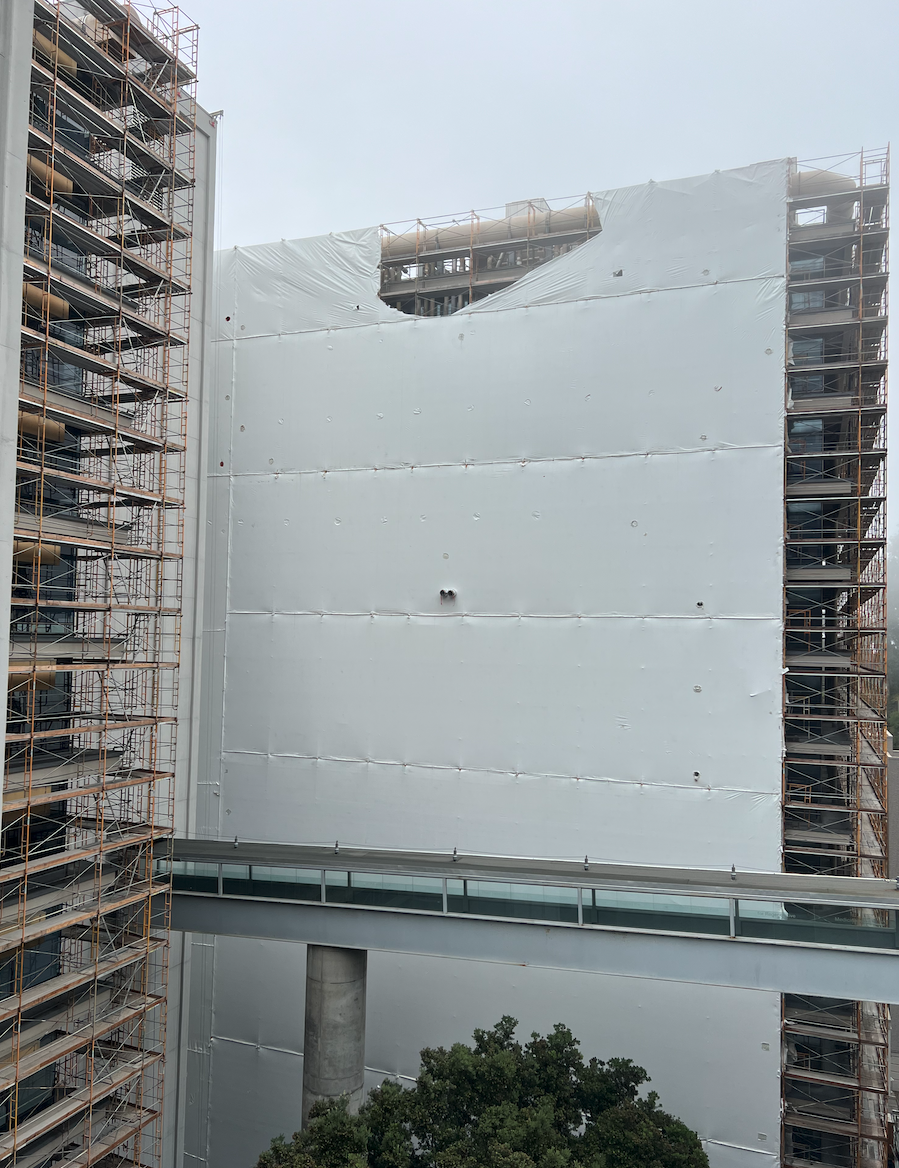 Exterior shrink wrap on the Health Sciences East tower from the south perspective.